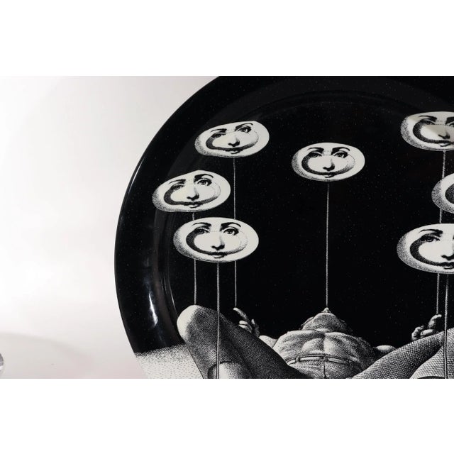 Fornasetti Tray Juggler with Spinning Plates, Atelier Fornasetti, Dated 2017, N 16 The black circular tray is printed with...