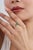 This elegant Toi et Moi bypass ring features a 1.41-carat oval-cut natural green emerald, set in 14k yellow gold. The...