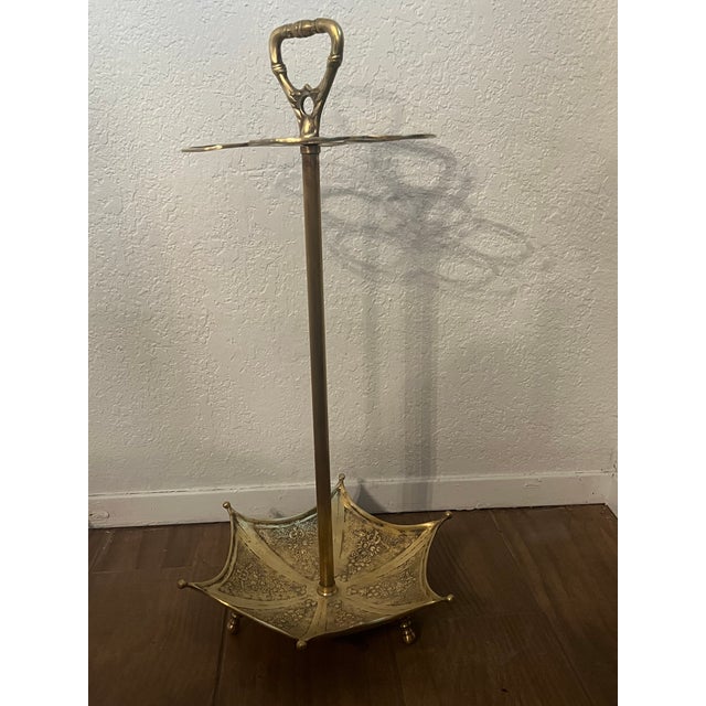 Vintage brass umbrella stand with intricate detail. Sits on legs and holds 5 umbrellas. In excellent vintage condition....