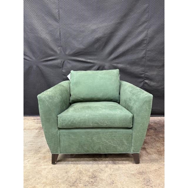 The Ellora Chair stuns in bottle green leather with a sleek City Dark finish—bold, sculptural, and undeniably chic.