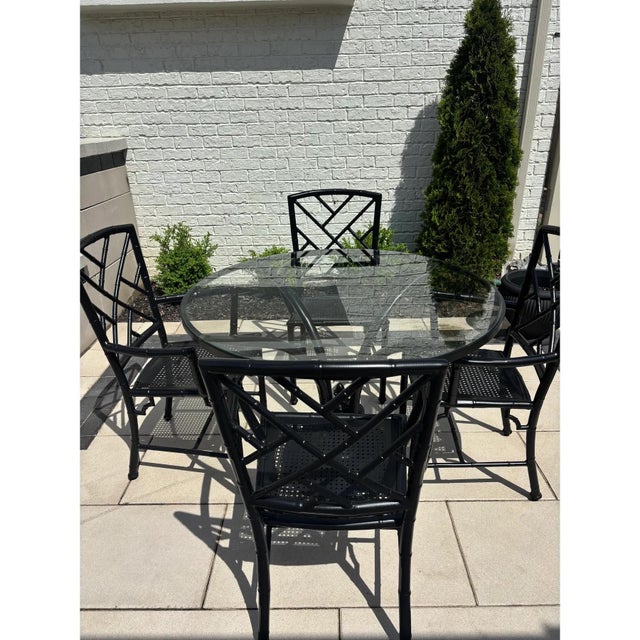 Offered is a five piece patio dining set by Meadowcraft. This set features a faux bamboo style frame with removable glass...