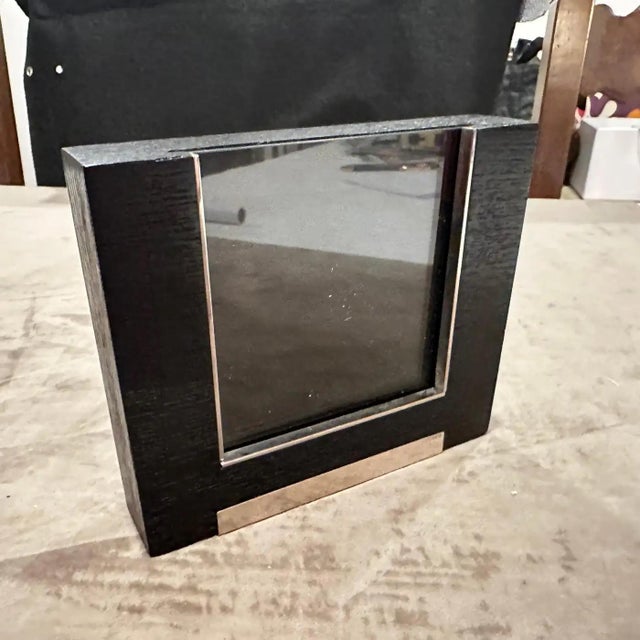 Sleek 1980s Modern Sterling Silver and Ebonized Wood Picture Frame by Silvan, Italy This exquisite picture frame is a...