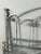 Elegant lacquered metal bed, dating from the 20th century. The frame features beautiful curved lines and openwork...