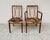 An elegant pair of vintage chairs and armchairs, crafted from solid teak, with exquisite curved details on the backrests....