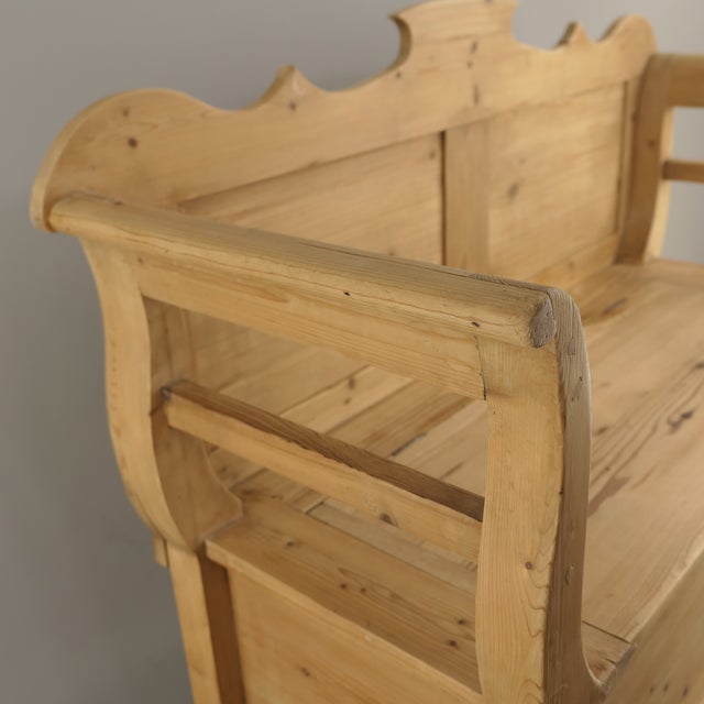 Small and light Antique Bavarian rustic softwood bench (Truhenbank) from circa 1900, featuring integrated armrests, a...
