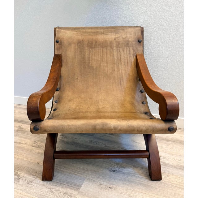 Vintage Mexican Butaque armchair, likely designed in the style of William Spratling or Clara Porset, featuring a curved...