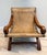 Vintage Mexican Butaque armchair, likely designed in the style of William Spratling or Clara Porset, featuring a curved...