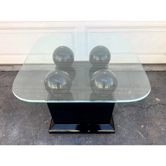 This is vintage lacquer table with faux marble spheres. Made in the 80’s perfect for that postmodern, Memphis modern style.