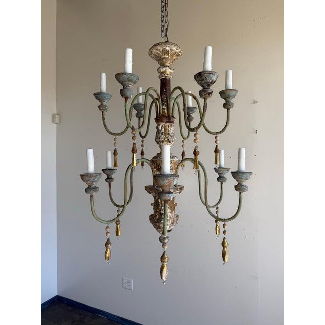 A spectacular Italian painted and giltwood chandelier, early 20th century, in the Baroque and Rococo revival taste. This...