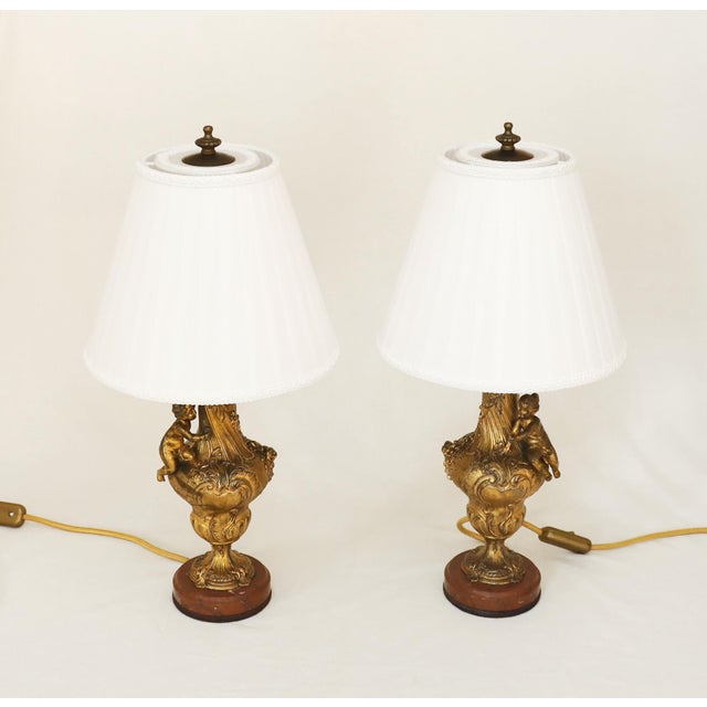 Pair of Art Nouveau Bronze Lamps Two antique Art Nouveau floor lamps, circa 1900. Vase-shaped with floral decoration and a...