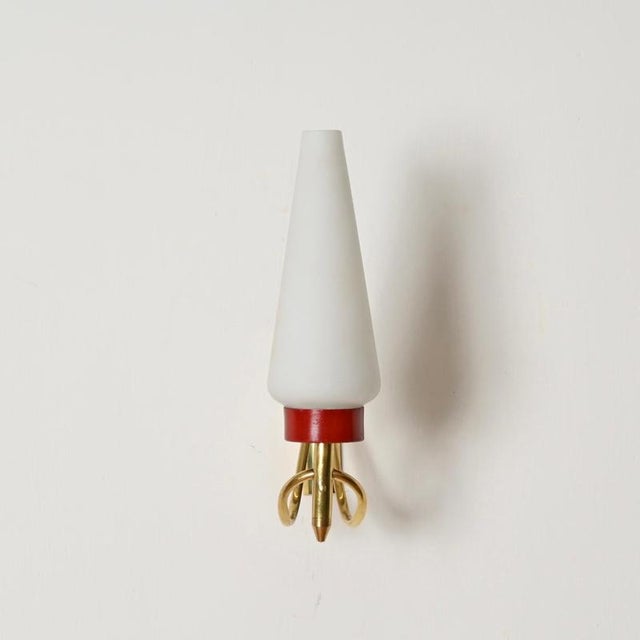 Stunning pair of mid-century wall sconces in opaline glass, red enameled metal and curved brass. These elegant wall lamps...