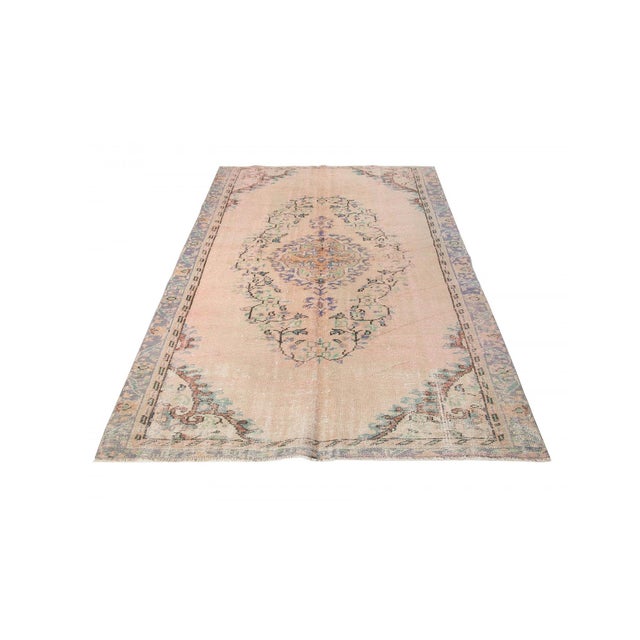 Decorative washed out handknotted vintage rug from Oushak region of Turkey. Approximately 50-60 years old. In very good...