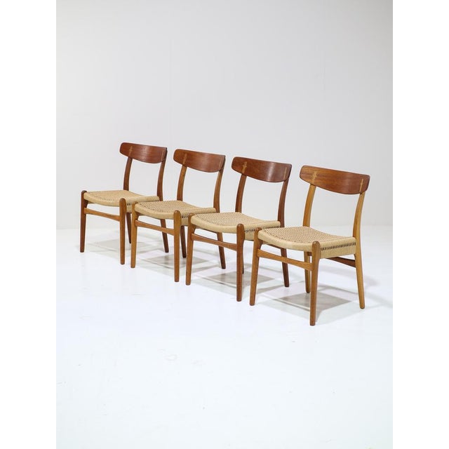 A set of four dining chairs, model ch23 designed by hans j. Wegner for carl hansen & son, denmark, 1950s. These chairs are...