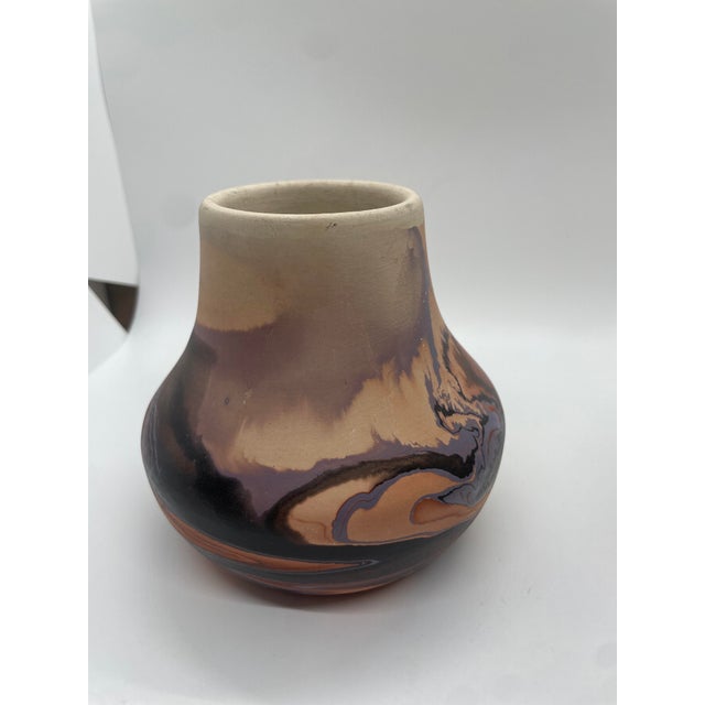 Transport yourself to the serene beauty of the Nemadji River with this mesmerizing swirl bowl crafted by Nemadji Indian...