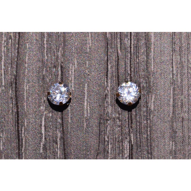 The Top: Top Hole Studs set with CZ. The studs feature specialty backs for top ear holes and are four prong set with Cubic...