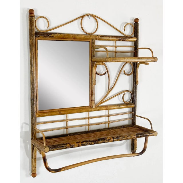 Unique vintage scorched bamboo wall unit featuring two shelves, a sizeable mirror and towel rack to bottom. Nice...
