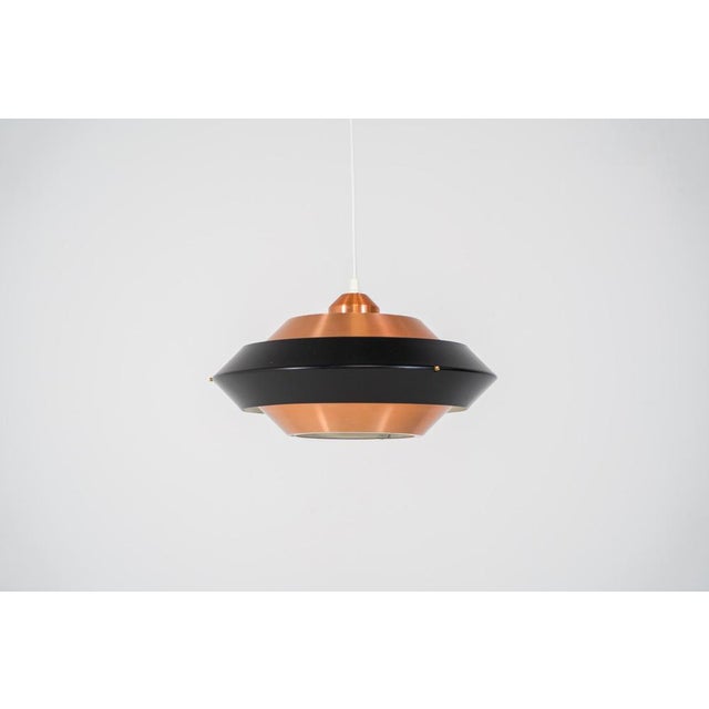Striking copper & black pendant light (Denmark, 1960s). This striking vintage pendant lamp features a refined combination...