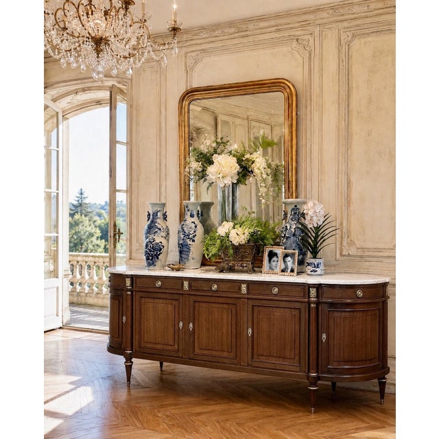 Grand French Louis XVI Mahogany Round-Sided Buffet with Carrara Marble is a magnificent example of the classical revival...
