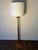 Striking vintage wood floor lamp with a tall, slender architectural profile and sculptural stepped geometric base. The...