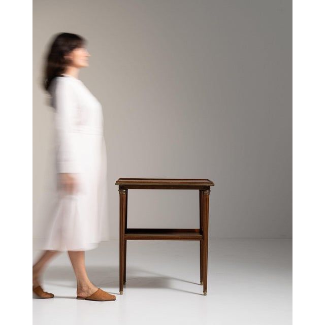Carved walnut side table with shelf in Rich Walnut Brown. The rich walnut brown surface highlights fluted legs, lower...