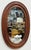 Vintage oval farmhouse style wood framed wall mirror. Features nice, rich natural wood tones with beveled frame. Natural...