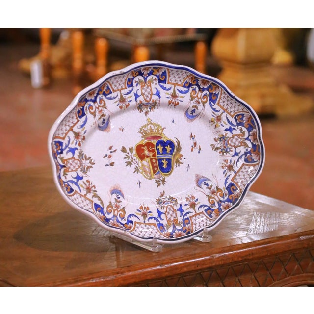Crafted in France circa 1850, this antique faience platter is decorated in the celebrated Rouen style, featuring a richly...