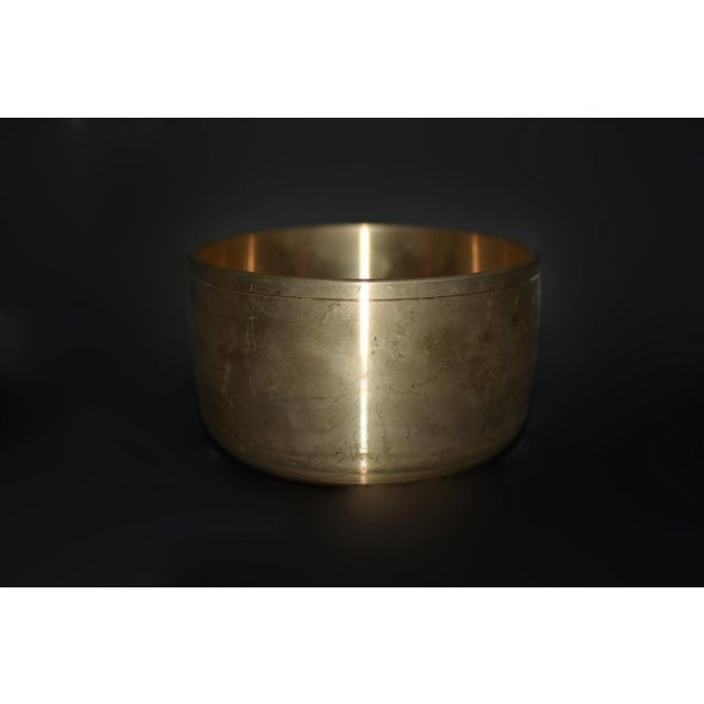 A solid golden brass Japanese singing bowls. The upright design and plain surface reflect modern sophistication while the...