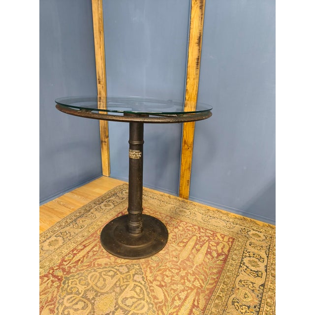 This industrial-style table was assembled from three parts by a skilled craftsman. It had a cast iron machine leg with a...