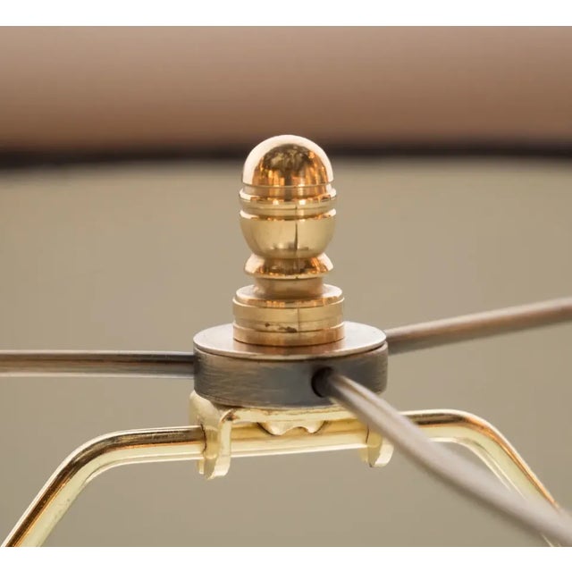 This refined pair of table lamps were realized in France, circa 1935. They feature three orbital forms with horizontal...