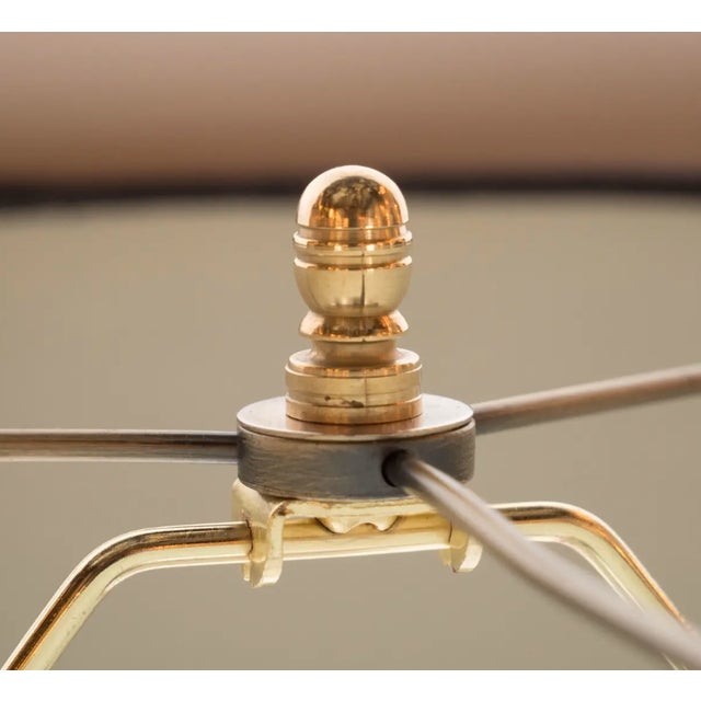 This refined pair of table lamps were realized in France, circa 1935. They feature three orbital forms with horizontal...