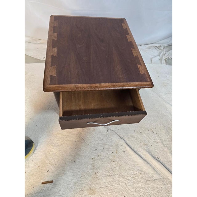 Vintage Lane AltaVista one-drawer end table showcasing classic mid-century modern design. Crafted in a warm walnut finish,...