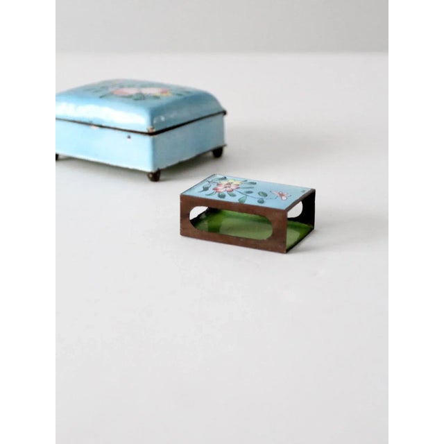 This is an antique Chinese cloisonne box with match box holder. Beautiful blue enamel with hand-painted floral and fruit...