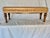 This 20th Century Leather Upholstered Bench dates back to the late 1900's. The piece features a tan or camel colored...