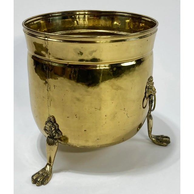 Very large antique English brass cachepot planter featuring three prominent feet and lion head handles. Large enough for...