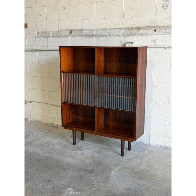 This striking storage unit introduces a dynamic architectural element with its multi-level open shelving and specialized...