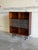 This striking storage unit introduces a dynamic architectural element with its multi-level open shelving and specialized...