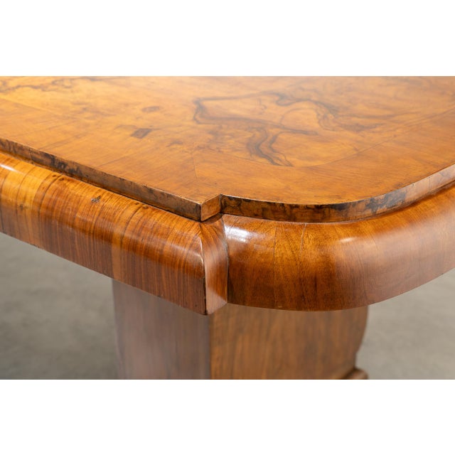 Large English Art Deco dining table on two pedestals, crafted from honey-colored walnut burl. The table disassembles into...