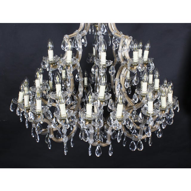 This is a beautiful English Ballroom crystal chandelier with forty-one lights arranged over in three tiers, circa 1920 in...
