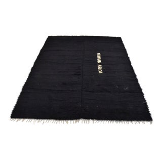 Vintage Turkish Tulu Kilim Rug With Woven Typography & Minimalist Jet Black Pile For Sale