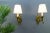 A beautiful pair of French Louis XVI-style wall lights. Made of bronze in the shape of large scrolls and decorated with...