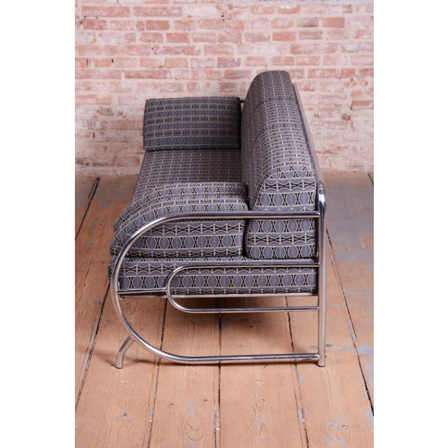 This elegant sofa from the early 20th century originates from the renowned Slezákovy závody workshop. Its frame is crafted...