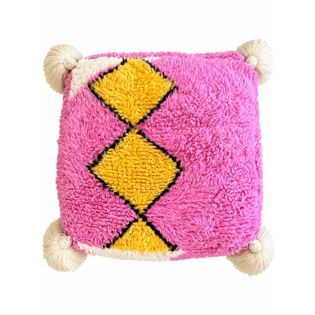 Moroccan floor pouf made from an abstract midcentury rug handwoven in ivory , yellow, camellia pink and black wool....