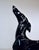 A Highly stylized, postmodern Art Deco-inspired sculpture that captures the sleek, dramatic lines of a life-size greyhound...