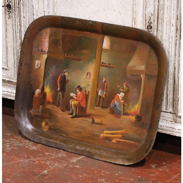 Charming antique French tôle tray crafted circa 1860 and decorated with a finely hand-painted genre scene depicting...