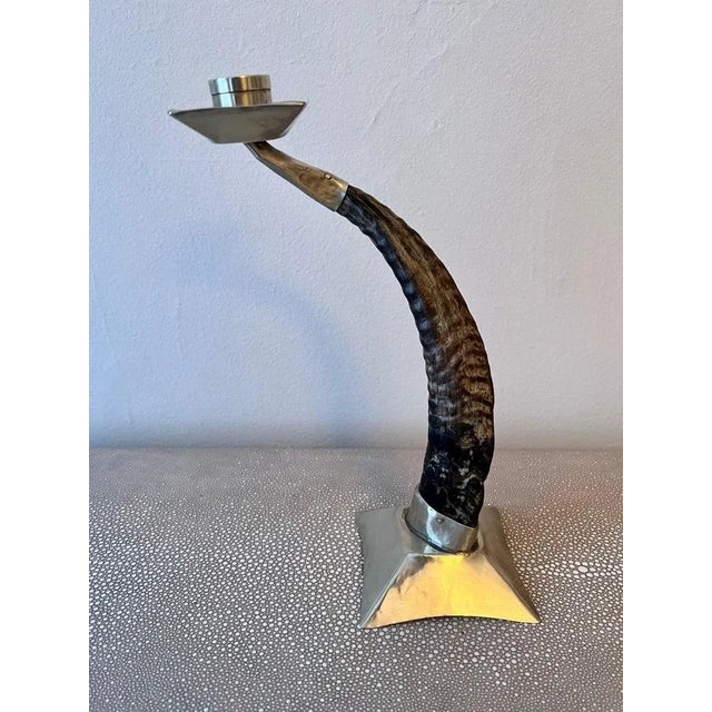 Candle stick holder made of ram's horn with silver base and candle cup. This is a vintage piece with good character and...