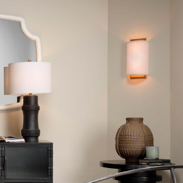 Brighten small spaces or lighten a dim hallway with this lovely artisan-crafted wall sconce. Clean, white linen softens...