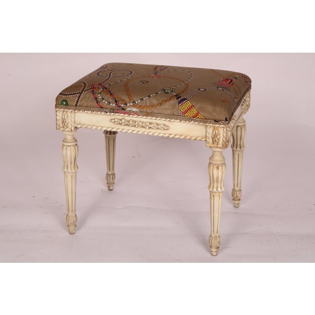 Pair of Louis XVI style painted benches, late 20th century. With upholstered seats, aprons with raised bellflowers, legs...