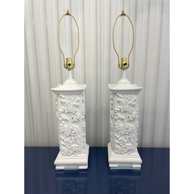 Pair of High-Gloss White Lacquer Chinoiserie Relief Table Lamps – 33” Striking pair of sculptural Chinoiserie-style table...