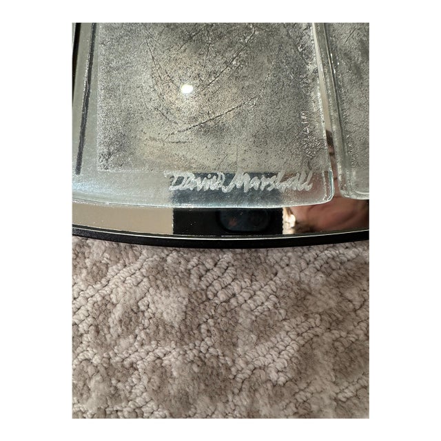 Signed, heavy 30-inch round mirror by designer David Marshall. Festures a wide frame made of individually cut antiqued...