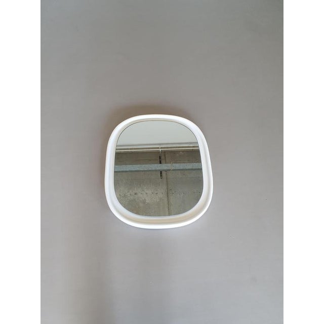 Set of 2 ceramic mirrors made by Sphinx Holland. Optically floating mirror in a white ceramic fame. Some wear on the edge...